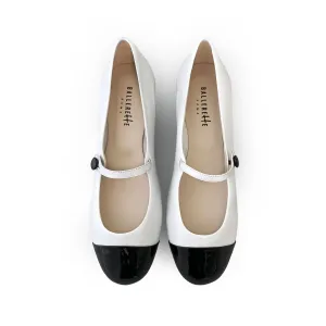 White ballet flats with black patent toe and strap