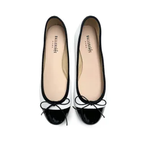 White leather ballet flats with black patent toe